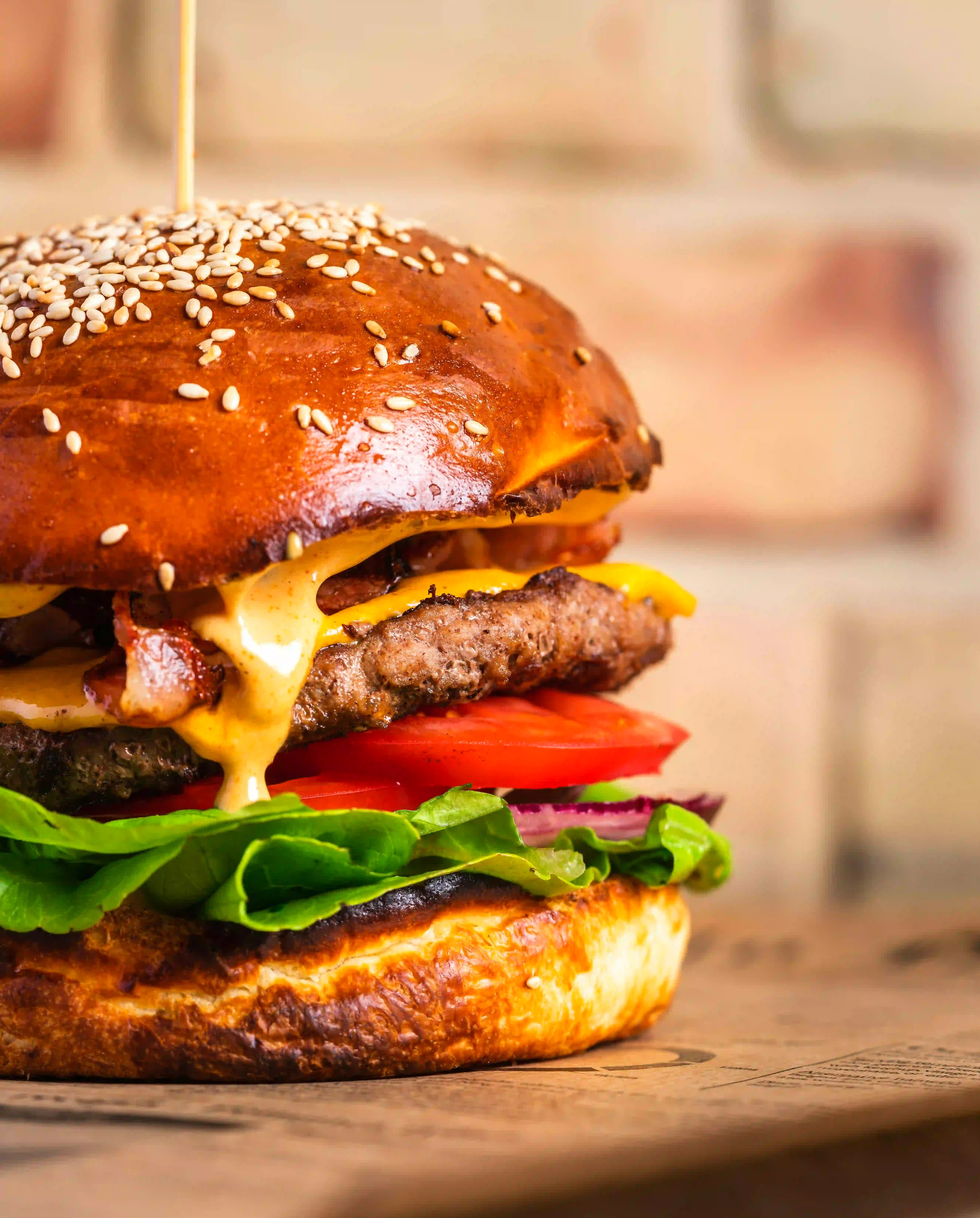 The Big Moo burger with melted cheese, crispy bacon, two patties, lettuce and beef tomato in a toasted sesame seed brioche bun